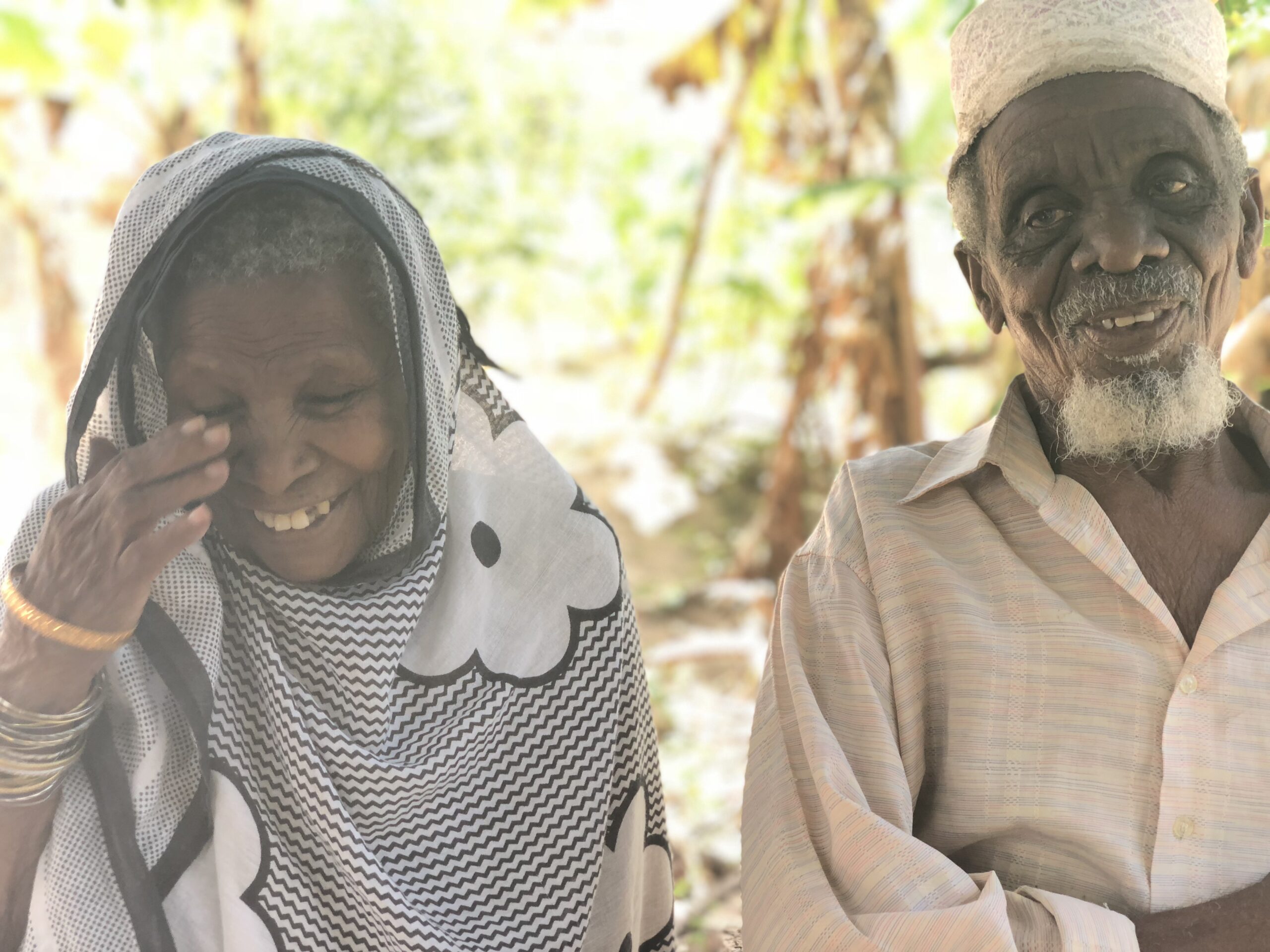 Two older adults laughing together
